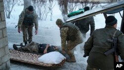 A Ukrainian soldier receives treatment in Avdiivka on January 31. Fighting between government forces and separatists supported by Russia has restarted although a ceasefire is in place.