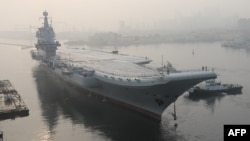 China's first domestically manufactured aircraft carrier, known only as "Type 001A", leaves port in the northeastern city of Dalian.