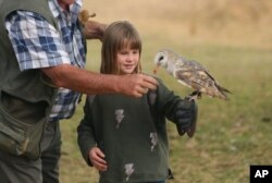 A child interacts with a bird at the Kuimba Shiri bird sanctuary near Harare, Zimbabwe, June 17, 2020.