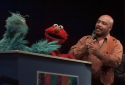 FILE - "Gordon" Roscoe Orman, right, talks with Rosita, left, and Elmo during a performance at the National Museum of American History in Washington, Feb. 23, 1999, to celebrate the 30th anniversary of Sesame Street.