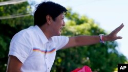 FILE - Vice-presidential candidate Sen. Ferdinand "Bongbong" Marcos Jr. waves to supporters during his campaign sortie in Muntinlupa city, southeast of Manila, Philippines, Feb. 22, 2016.