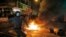 A rioter tries to throw bricks at police in Mong Kok district of Hong Kong, Feb. 9, 2016.