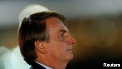 Brazil's President Jair Bolsonaro looks on while meeting supporters and as he arrives at Alvorada Palace amid the COVID-19 outbreak in Brasilia, Brazil, April 8, 2020. 