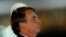 Brazil's President Jair Bolsonaro looks on while meeting supporters and as he arrives at Alvorada Palace amid the COVID-19 outbreak in Brasilia, Brazil, April 8, 2020. 