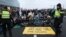 Police talk with climate activists blocking the main highway around Amsterdam near the former headquarters of ING bank on Dec. 30, 2023. They were protesting the financing of fossil fuels.