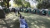 FILE: Members of the public wait to be tested for HIV and AIDS in Harare, Zimbabwe, June, 22, 2012.