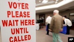 A voter is escorted to a voting machine on Election Day Nov. 8, 2016, in Nashville, Tennessee.