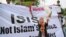 FILE - A woman releases a dove as a symbol of peace during a rally against the Islamic State group, in Jakarta, Indonesia. 