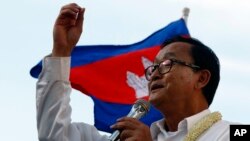 In this file photo taken on Dec. 22, 2013, Cambodian opposition leader Sam Rainsy of the Cambodia National Rescue Party delivers a speech before his party supporters during a rally in Phnom Penh, Cambodia.