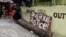 A sign reading "Overkill Justice for Eric" is displayed at the entrance of a street where Eric Quintinita Sison was killed in Pasay city, Metro Manila in the Philippines, Aug. 29, 2016. Family members of Sison said he was attempting to surrender when he was gunned down by police during a meth bust.