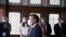 French President Emmanuel Macron speaks with officials at a polling station during the second round of French municipal elections, in Le Touquet-Paris-Plage, France, June 28, 2020.