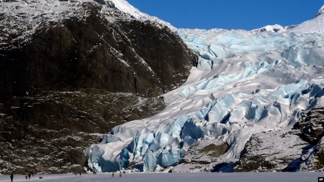 FILE - People walk near the Mendenhall Glacier on Feb. 9, 2025, in Juneau, Alaska. 