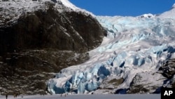 FILE - People walk near the Mendenhall Glacier on Feb. 9, 2025, in Juneau, Alaska. 