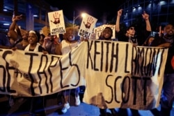 FILE - In this Friday, Sept. 23, 2016 photo, protesters shout as they march in the streets of Charlotte, N.C., to protest the fatal police shooting of Keith Lamont Scott.