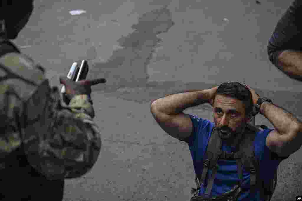 M23 rebels escort Romanian mercenaries to the border crossing into Rwanda in Goma, Democratic Republic of Congo.