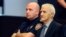 FILE - Dragan Vasiljkovic, right, a former Serb military commander sits between guards in a courtroom at the beginning of his trial in Split, Croatia, Sept. 20, 2016. Vasiljkovic is accused of overseeing the torture and murder of civilians and prisoners in Croatia in the early 1990s.