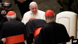 Pope Francis greets cardinals in the Paul VI Hall at the Vatican after an audience with students and teachers of the LUMSA Catholic University, Nov. 14, 2019.