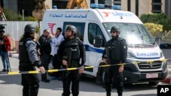 Police officers guard the blast site near the US Embassy in Tunis, March 6, 2020.