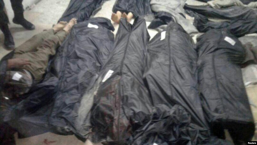 Covered dead bodies lie on the ground after Islamic State fighters killed 20 people in the village of Aqarib al-Safi, east of Hama city, Syria in this handout picture provided by SANA on May 18, 2017.