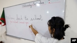 FILE - A teacher gives an English lesson in a private school of Birkhadem, outside Algiers, Wednesday, Sept.21, 2022. English proficiency in Algeria has remained stable since 2021. (AP Photo/Fateh Guidoum)
