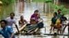 Flood-affected residents use bamboo rafts as they move to higher ground in Taungoo, Myanmar's Bago region, on Sept. 14, 2024, following heavy rains in the aftermath of Typhoon Yagi.