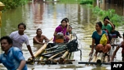 Flood-affected residents use bamboo rafts as they move to higher ground in Taungoo, Myanmar's Bago region, on Sept. 14, 2024, following heavy rains in the aftermath of Typhoon Yagi.