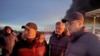 In this photo released by Governor of the Saratov region Roman Busargin telegram channel on Jan. 8, 2025, Busargin, right, speaks to firefighters and rescuers after a Ukrainian drones attack in Russia. (Governor of the Saratov region Roman Busargin telegram channel via AP)