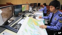 South Korean officials of the Incheon Maritime Police Agency monitor a situation room while on high alert in preparation for North Korea's planned launch of a Unha-3 rocket, in Incheon, South Korea, April 12, 2012.