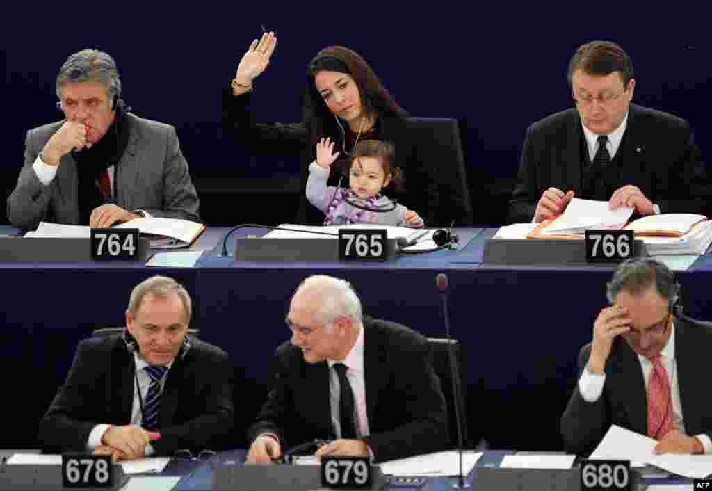 Italy's Member of the European Parliament Licia Ronzulli takes part with her daughter in a voting session at the European Parliament in Strasbourg February 15, 2012. (Reuters)