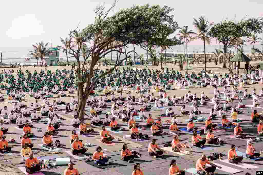 Yoga enthusiasts take part in a mass yoga session at North Beach in Durban, South Africa. 