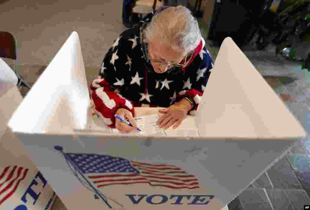 Maria Morahn, of Osceola, Iowa, casts her ballot in the general election, Nov. 6, 2018, at the United Methodist Church in Osceola, Iowa.