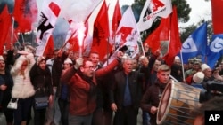 Supporters of the Albanian main opposition Democratic Party chant slogans during a protest in front of the government building in Tirana, Albania, Feb. 18, 2017.