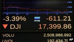 A screen above the floor of the New York Stock Exchange shows the closing number for the Dow Jones industrial average, Friday, June 24, 2016.