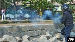 Police tear gas children from the Langata Road Primary School during a protest over a land dispute Jan. 19, 2015 in Nairobi.