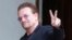 FILE - U2 singer Bono makes a peace sign as he arrives for a meeting at the Elysee Palace, in Paris, France, July 24, 2017.