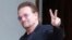 FILE - U2 singer Bono makes a peace sign as he arrives for a meeting at the Elysee Palace, in Paris, France, July 24, 2017.