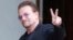 FILE - U2 singer Bono makes a peace sign as he arrives for a meeting at the Elysee Palace, in Paris, France, July 24, 2017.