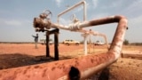 FILE - Oil spills onto the ground from an oil well head in South Sudan, March 3, 2012. South Sudan Petroleum Minister Awou Daniel Chuag has warned that more oil spills are likely given the poor condition of many pipelines.