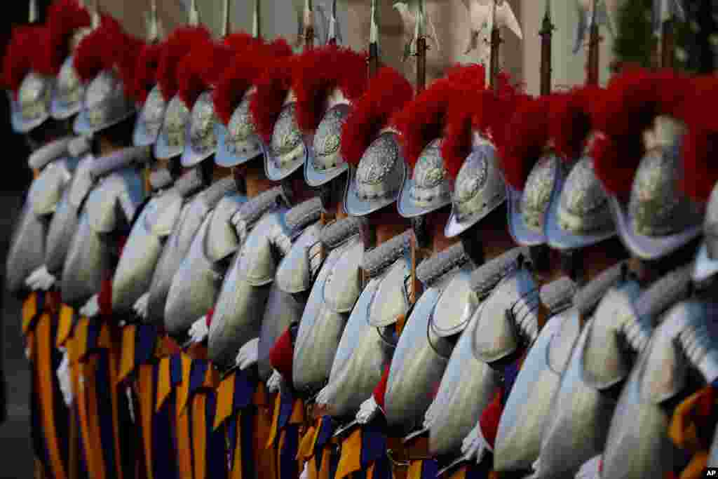 Vatican Swiss Guards stand attention at the St. Damaso courtyard on the occasion of their swearing-in ceremony, at the Vatican.
