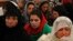 Women listen to a speech by Afghanistan's President Hamid Karzai during a district assembly gathering, in Kabul, May 30, 2013. 