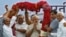 FILE - Narendra Modi gestures as he receives a garland from his supporters during a public meeting in Vadodara, in the western Indian state of Gujarat, May 16, 2014.