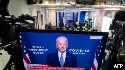 President-elect Joe Biden speaks about coronavirus as he appears on a television in the Brady Press Briefing Room of the White House in Washington, Nov. 9, 2020. 