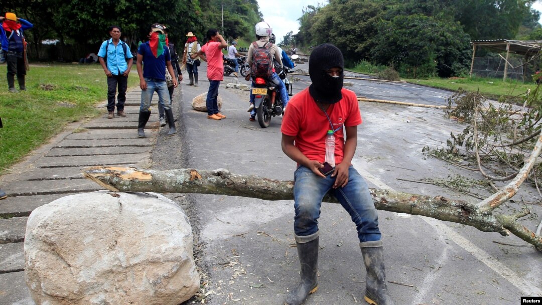 FILE - Indigenous people protest against the goverment, demanding land reform and increased state spending in rural areas, at the Panamerican highway in Mondomo, Cauca, Colombia, June 3, 2016.