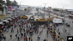 Demonstrators close the Pan-American highway during a protest against elimination of fuel subsidies announced by President Lenin Moreno, in Quito, Ecuador, Oct. 3, 2019.