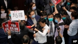 Pan-democratic legislators scuffle with security guards and pro-China legislators at the Legislative Council's House Committee meeting in Hong Kong, May 8, 2020. 