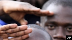 Youth supporters of Ivory Coast's Laurent Gbagbo gather at a stadium at army headquarters in Abidjan to sign up for military service, March 21, 2011
