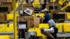 Workers select products during Cyber Monday at Amazon's fulfillment center in Robbinsville, N.J., Dec. 2, 2024.