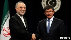 FILE - Turkey's Foreign Minister Ahmet Davutoglu and Iranian counterpart Ali Akbar Salehi, left, at news conference, Ankara, Jan. 19, 2012.