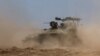 Israeli military vehicles manoeuvre, near the Israel-Gaza border