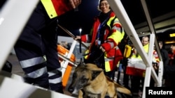 Rescuers of International Search and Rescue (ISAR) Germany board a charter plane, on their way to help find survivors of the deadly earthquake in Turkey, at Cologne-Bonn airport, Germany, Feb. 7, 2023. 